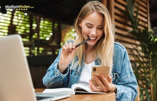 Junge Frau die auf ein Smartphone schaut