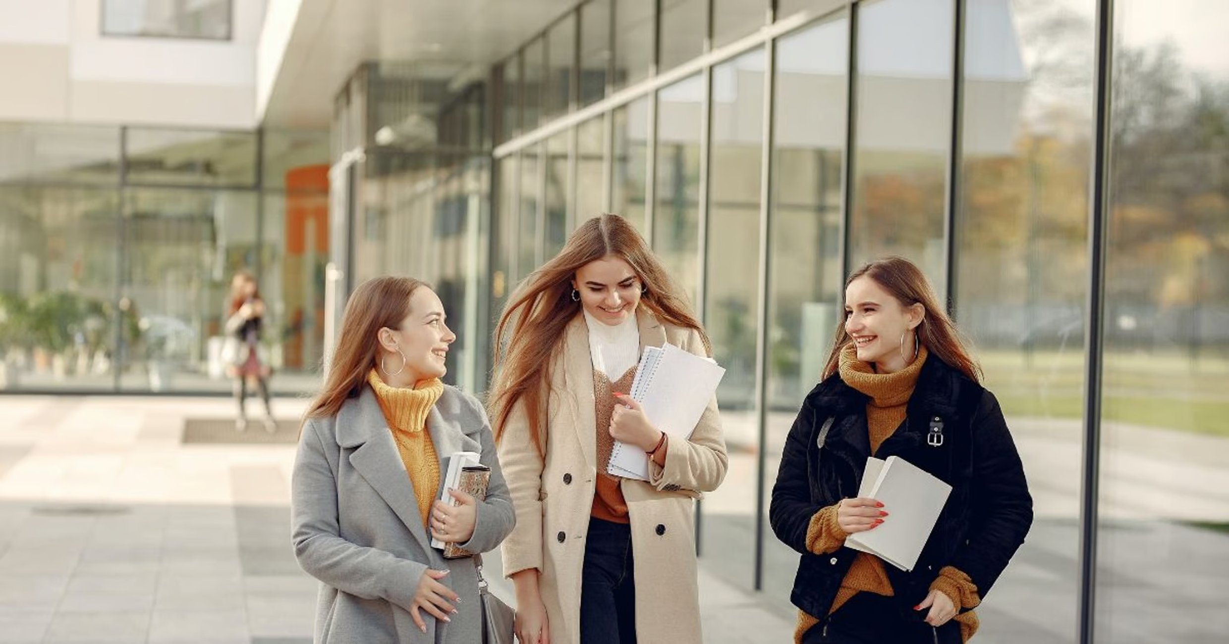 Three woman in front of university