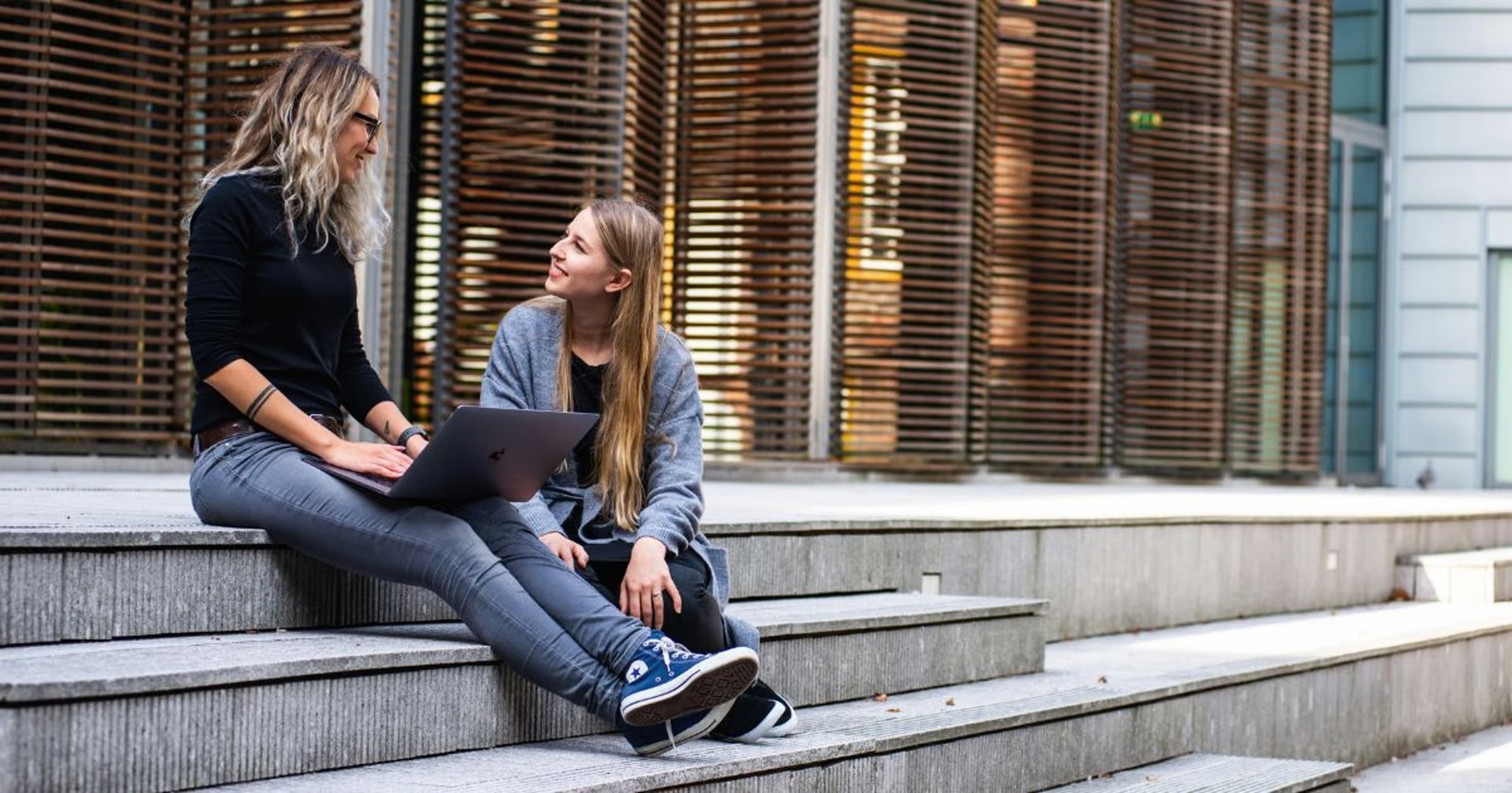 Two women sitting on stairs
